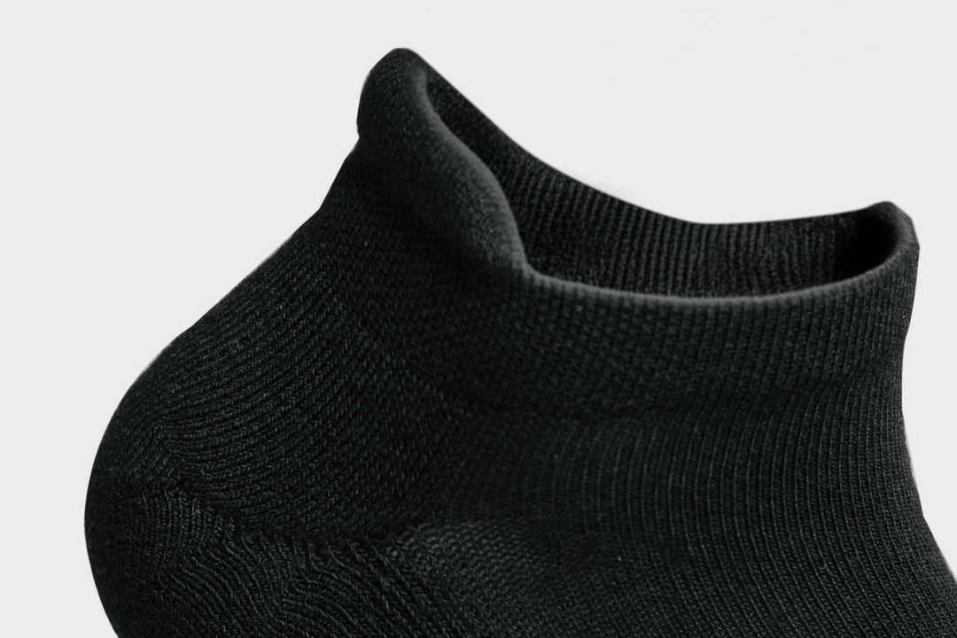 Close-up of the heel tab and fine knit on a black DryStep Ankle Tab sock
