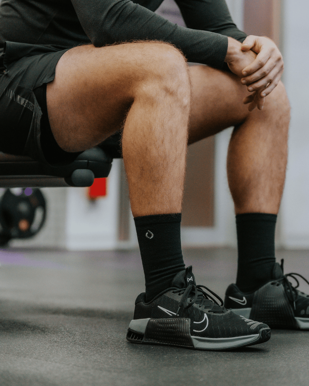 Man wearing DryStep black crew socks at gym — moisture-wicking performance sock