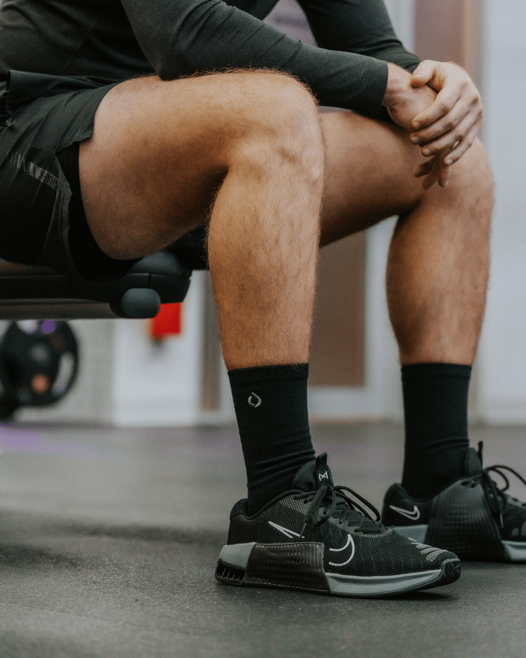 Man wearing DryStep black crew socks at gym — moisture-wicking performance sock