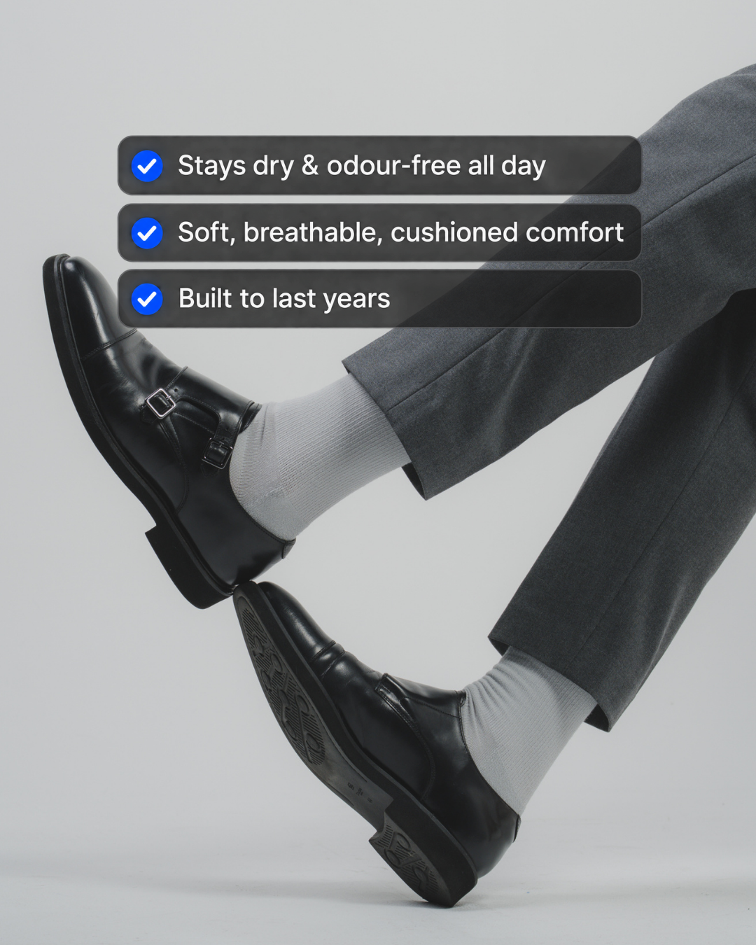 Man wearing DryStep stone grey crew socks at office with benefits — all-day performance dress sock