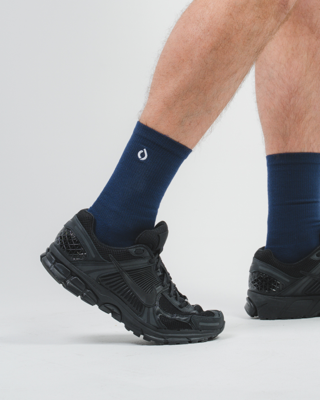 Man running in DryStep midnight navy crew socks — cushioned moisture-wicking performance