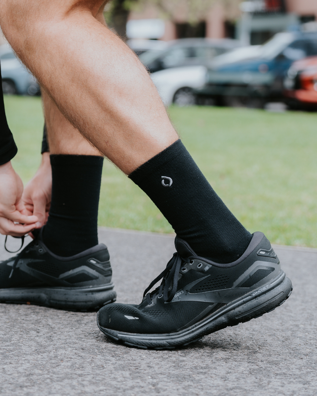 Man running in DryStep black crew socks — sweat-wicking cushioned performance sock