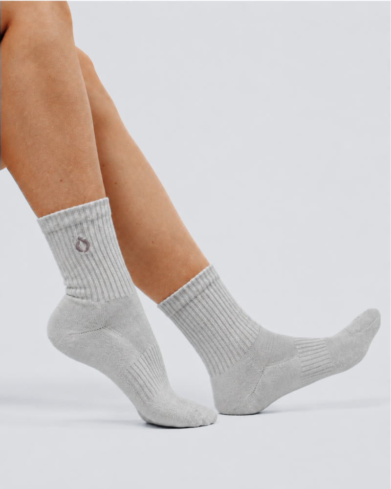 Woman wearing DryStep mist grey mid-crew socks — moisture-wicking Coolmax with cushioned sole