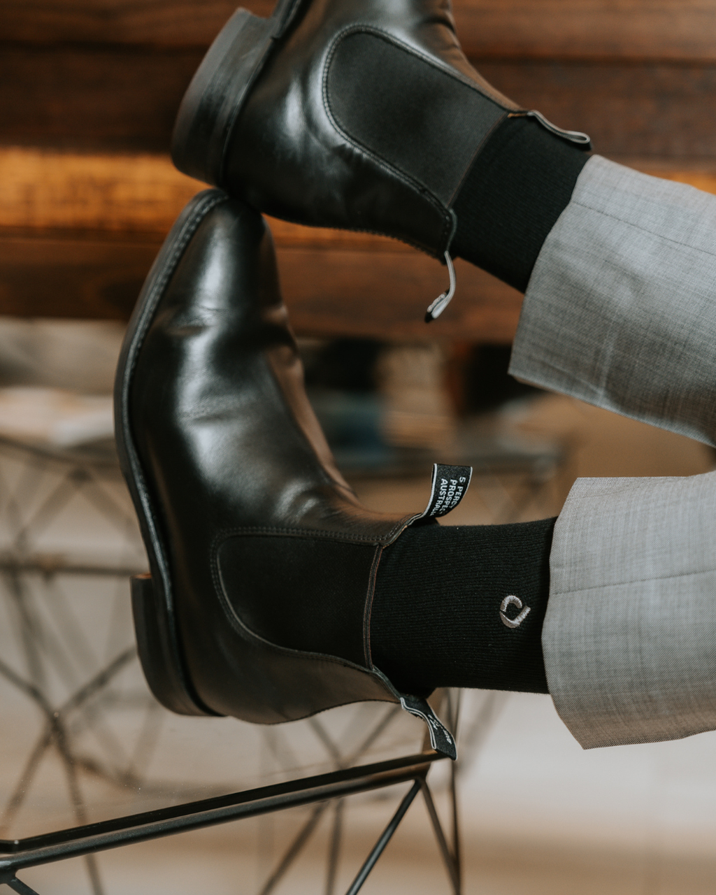 Man wearing DryStep black crew socks at office — sweat-proof dress socks