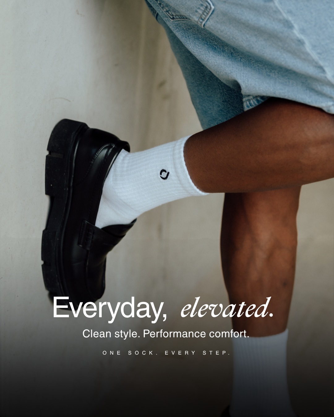 White mid-crew sock worn with black leather sneakers